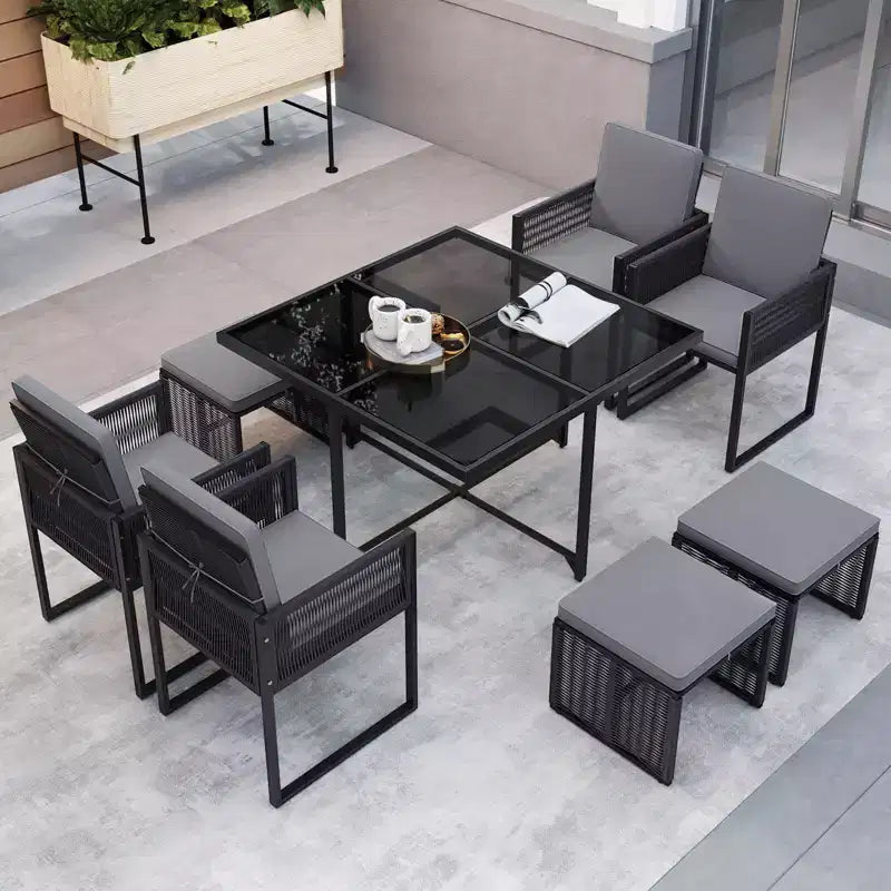Costway Set da Pranzo da Giardino 9 Pezzi con Sedie in Rattan PE, Tavolo in Vetro Temperato e Pouf